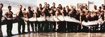 lots of men holding a giant Oarfish