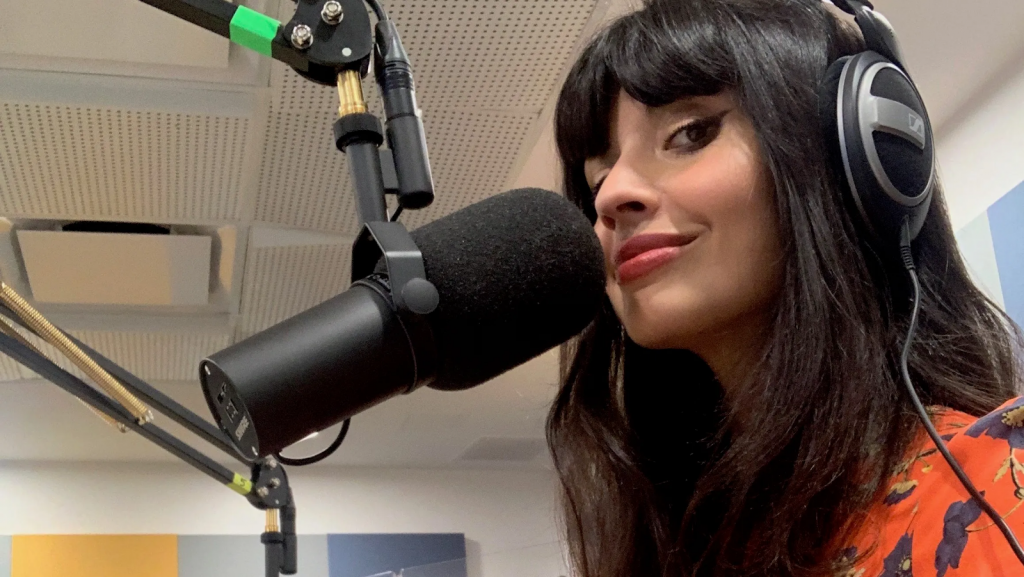 Actress and podcaster Jameela Jamil in front of  a microphone